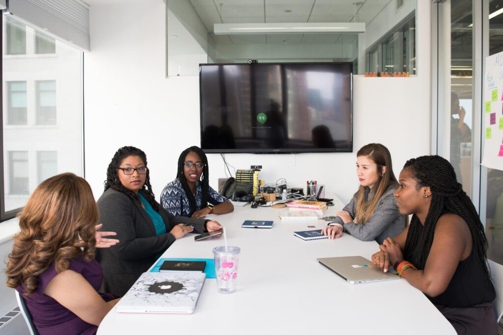 Women workers around a table talking